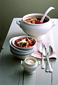Borscht with lamb shank, white cabbage and sour cream in bowl