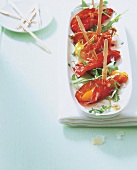 Bresaola rolls with skewers on tray for antipasti