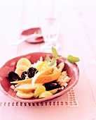 Couscous with marinated fruit in ceramic bowl