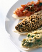 Close-up of crostini with tomato, chicken liver and eggplant spread on white plate