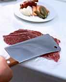 Beef disc thinly pounded with meat cleaver