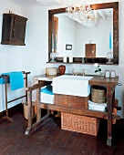 Old fashioned mirror and dark wood table in bathroom