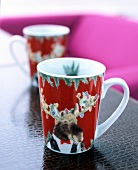 Red and white coffee mug with Christmas elchmuster