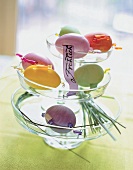 Goose egg and various coloured Easter eggs on glass stand with message on jewellery band