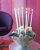 Christmas arrangement in silver bowl with candles and roses