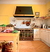Black hood and cast-iron stove with two oven and cabinets in kitchen