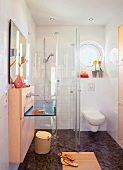 Interior of bathroom with glass shower enclosure and sink