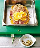 Suckling pig with oranges on tray