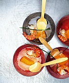 Clear Japanese soup with melon and prawns in bowls