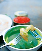 Mackerel with cucumber and lettuce vinaigrette in bowl with fork