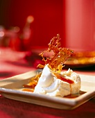 Close-up of fresh goat cheese with tomato coulis served on square plate