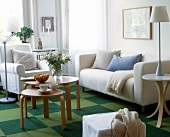 View of living room with white sofa and checkered patterned carpet