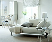 Living room with white furniture, chaise lounge, secretary desk and lamp