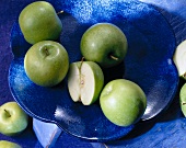 Green apples on flower shape plate