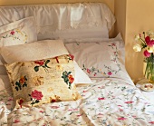 Close-up of bed with floral embroidered bed sheet