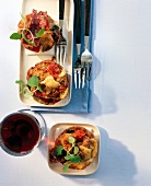 Pizza muffin garnished with herbs, peppers and red tea kept on white surface