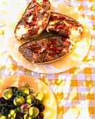 Close-up of tapas dishes with bread, tomato and olive