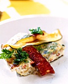 Thin flatbread with eggplant, onions and chorizo on plate