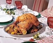 Roasted turkey with lemons on serving dish at Christmas