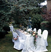 Outdoor table and chair decorated in white