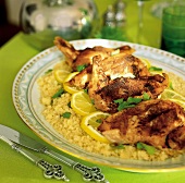 Close-up of lemon chicken with couscous and lemon slice on plate