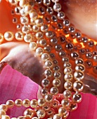 Close-up of shiny pearl necklace on shell