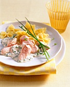 Farfalle and salmon with chive cream on plate