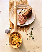 Bouillon potatoes in wooden spoon with veal fillet in mustard-herb sauce