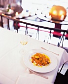 Fried monkfish with curry and mashed sweet potatoes on plate