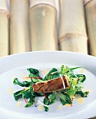 Close-up of tuna belly glazed with soy, ginger and honey, marinated vegetables on plate