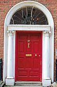 rote Haustür in georgianischer Fassade close-up
