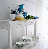 Country style chest in white with colourful milk jugs on it