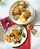 Fish fillet with lentils and swordfish with herbs and lemon sauce on plate, overhead