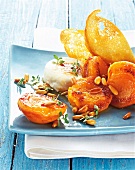 Close-up of grilled apricots with goat cheese on serving dish