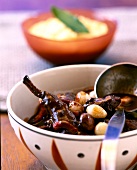 Civet de Lievre, wild rabbit stew with polenta in bowl