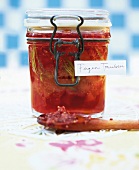 Close-up of fig and grape jam with tarragon in glass jar