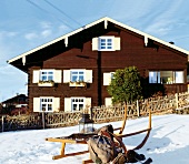 View of farmhouse and winter sled in Bavaria, Germany