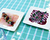 Carpaccio of white tuna and beef on plates