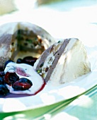 Close-up of cassata with cherry sauce and zabaglione on plate