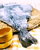 Close-up of dried bacalao cod fish on wicker plate