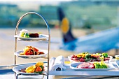 Appetizers on etagere and tandoori chicken breast on tray