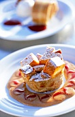 Brioche pudding with apples and cinnamon cream on plate