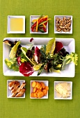 Salad compilation with extra virgin olive oil on plate, overhead view