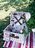 Wicker basket with crockery for picnic