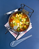 Vegetable soup with mini farfalle, pasta noodle and vegetables in bowl