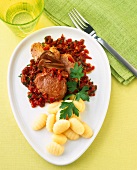 Pork fillet with porcini mushroom sauce, gnocchi on plate
