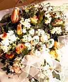 Close-up of wreath with tulips, roses and painted Easter eggs