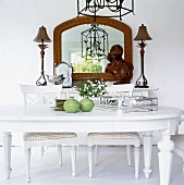 Mirror table and white dining table with silver tray flowers pot,
