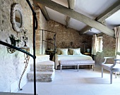 Bedroom with beamed ceiling and double bed in Provence, France