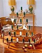 Folds Anne wooden tree with green and white candles on wooden floor